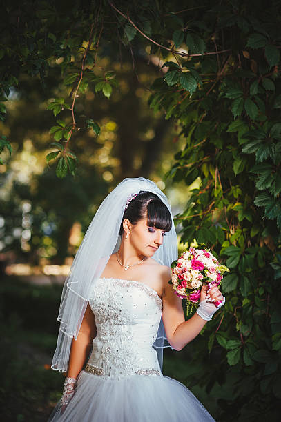 istock Beautiful bride posing in her wedding day 474573382