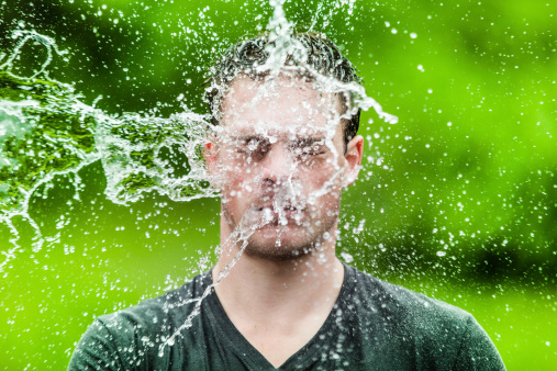 Young Adult That Got Completely Drenched with Green Background