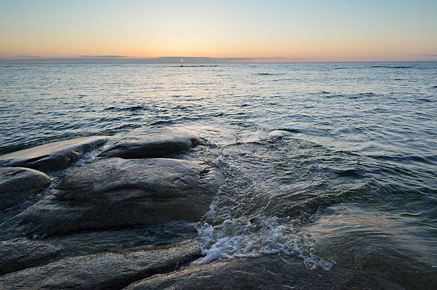 istock Rocky coast with waves at sunset 474575170