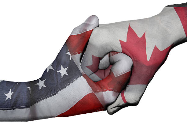 Diplomatic handshake between countries: flags of United States and Canada overprinted the two hands