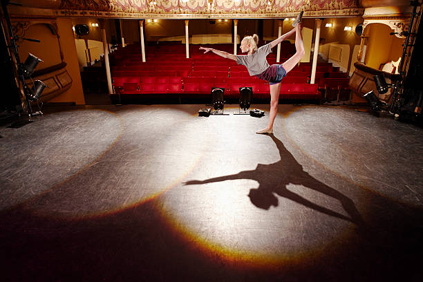 istock Young Woman Stretching On Stage 474585109