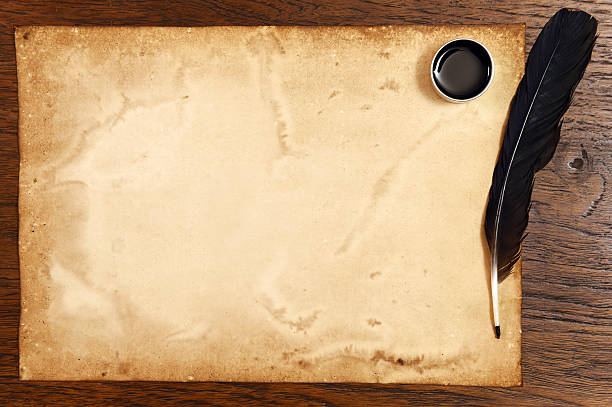 istock old paper on brown wood texture with feather and ink 474586982