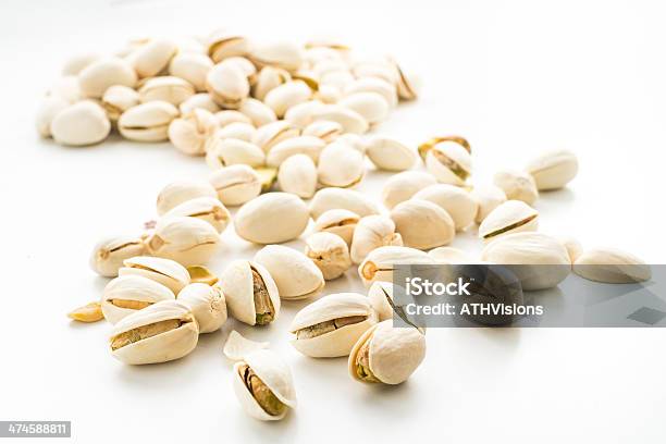 Pistachio Nuts On White Isolated Stock Photo - Download Image Now - Brown, Close-up, Cracked