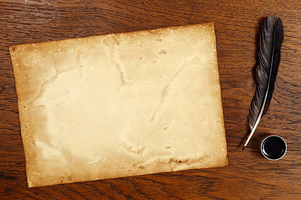 istock old paper on brown wood texture with feather and ink 474589872