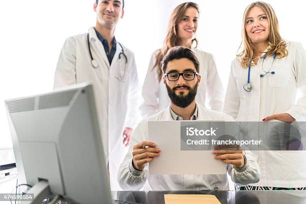Teamwork Of Doctors In The Office For A Meeting Stock Photo - Download Image Now - Billboard, Doctor, 20-29 Years