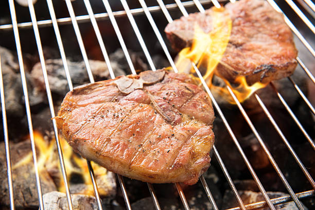 istock Grilled pork chop on the flaming grill 474590804