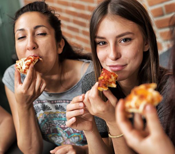 istock Women Eating Pizza 474593522