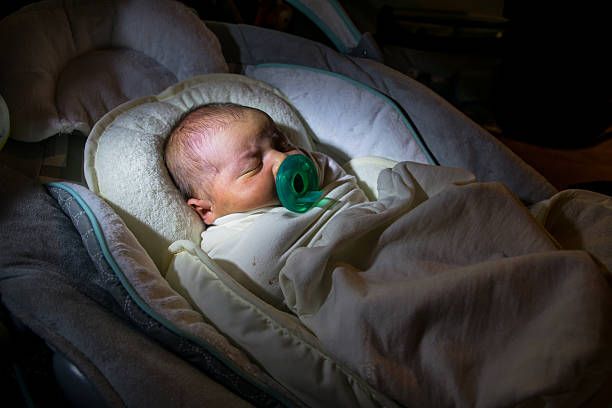 istock Infant Newborn Baby Sleeping with Pacifier at home 474593798