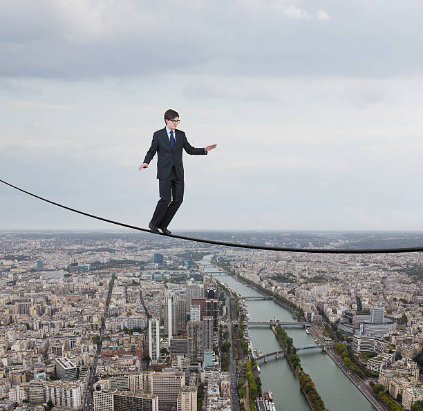 istock businessman walking on a rope 474593814