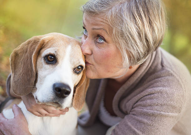 istock Active senior woman hugs dog 474597619