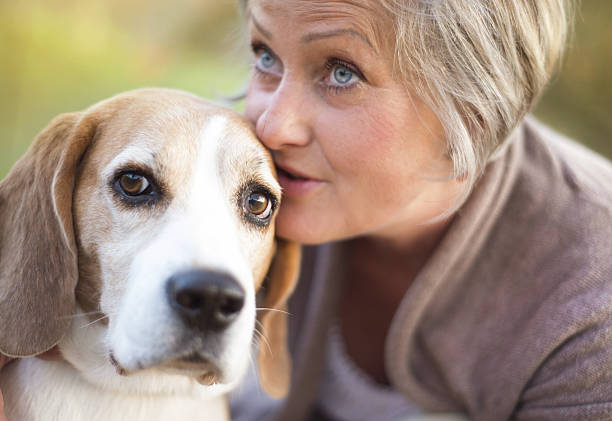 istock Active senior woman hugs dog 474597629
