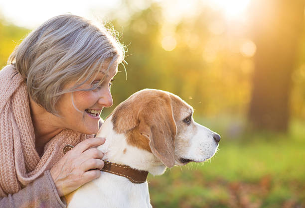 istock Active senior woman hugs dog 474597697