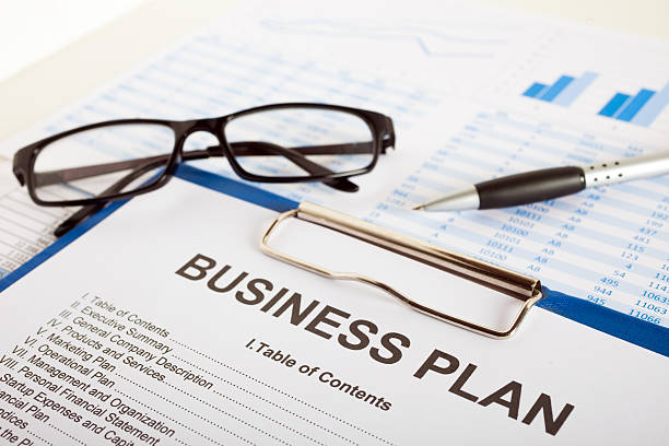 Business plan Business plan over financial charts business plan stock pictures, royalty-free photos & images