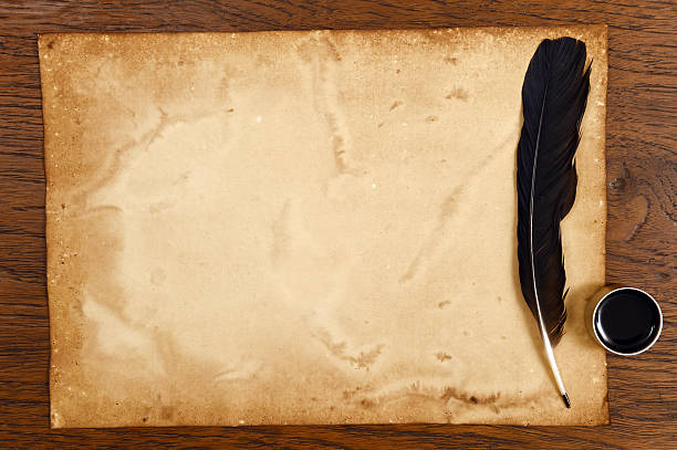 istock old paper on brown wood texture with feather and ink 474599546