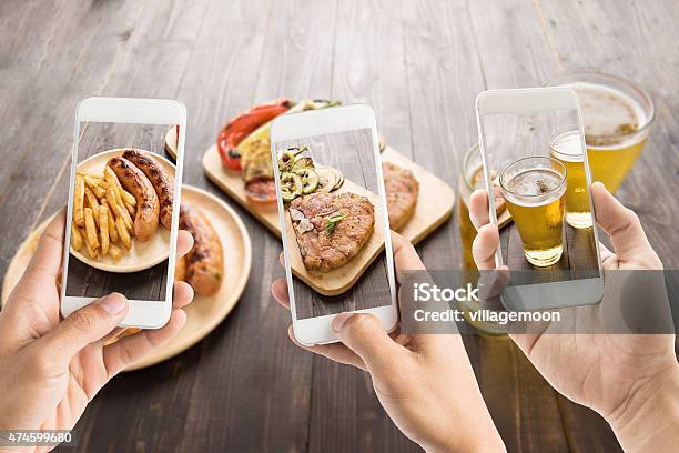 Friends Using Smartphones To Take Photos Of Food Stock Photo - Download Image Now - Food, Three People, Telephone