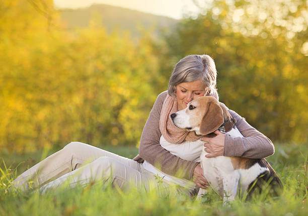 istock Active senior woman hugs dog 474600885