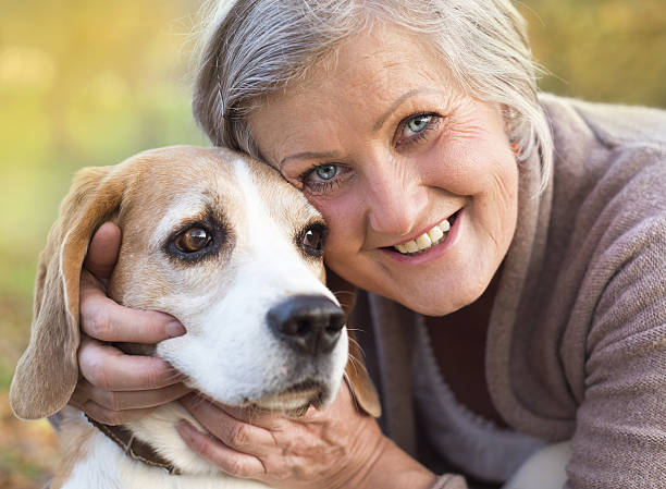 istock Active senior woman hugs dog 474600895