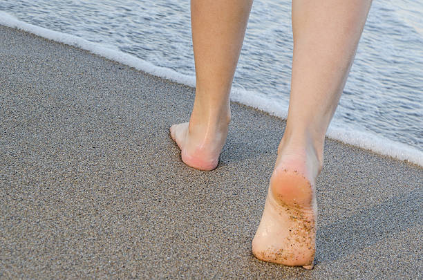 istock Woman walking  on the beach 474601291