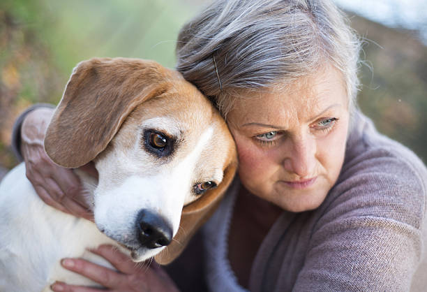 istock Active senior woman hugs dog 474601343