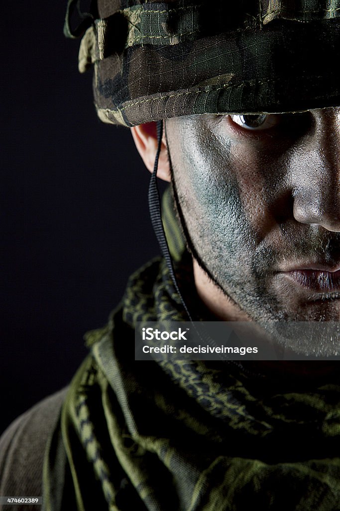 Soldier portrait Close up portrait of a serious male Caucasian soldier wearing camoflage face paint. Military Stock Photo