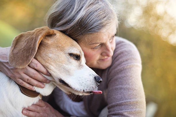 istock Active senior woman hugs dog 474602513