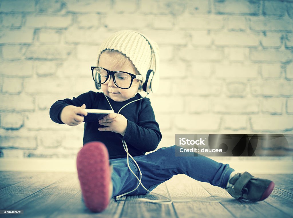 Little nerd with music player 18-23 Months Stock Photo
