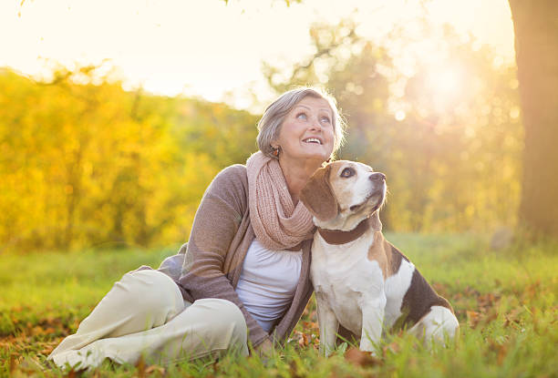 istock Active senior woman hugs dog 474602819