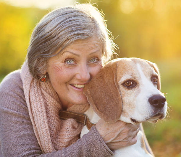 istock Active senior woman hugs dog 474602821