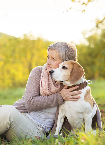 istock Active senior woman hugs dog 474602829