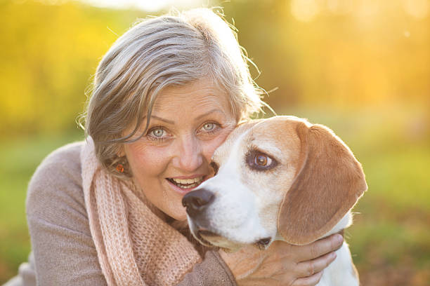 istock Active senior woman hugs dog 474602843