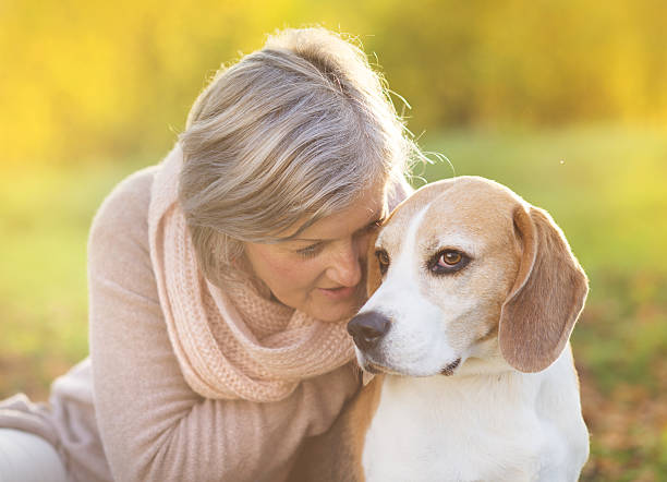 istock Active senior woman hugs dog 474602853
