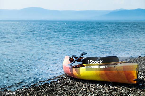 Orange And Yellow Kayak With Oars On The Sea Shore Stock Photo - Download Image Now - Activity, Adventure, Beach