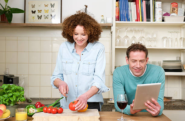 istock Happy husband and wife cooking in the kitchen 474607502