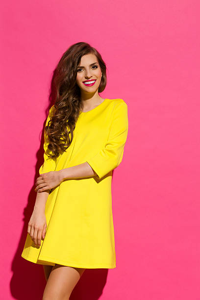 istock Smiling Beautiful Girl Against Pink Wall 474608350