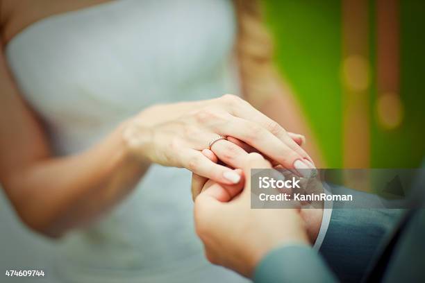 Groom Placing An Engagement Ring Stock Photo - Download Image Now - 2015, Adult, Adults Only