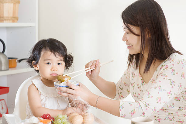 istock Asian mother feeding child 474609838