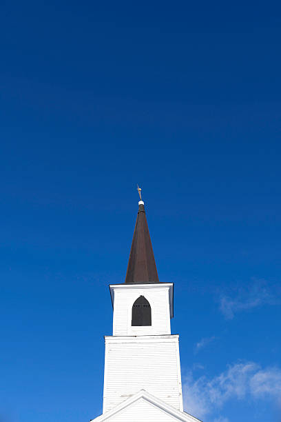 istock Church steeple against blue sky with clouds 474610860