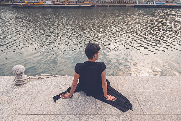istock Handsome Asian model sitting by an artificial basin 474611616
