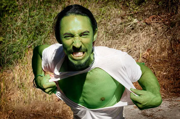 green man tearing his clothes