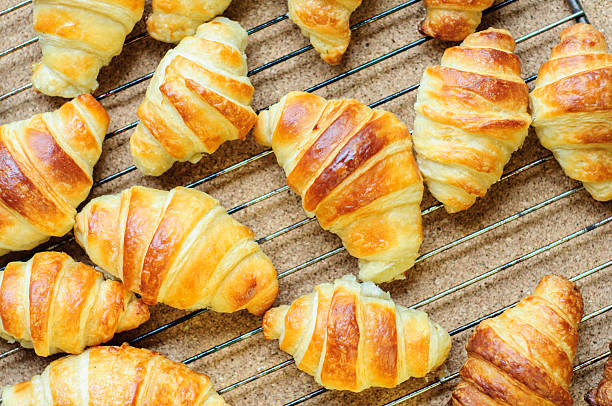 istock Fresh baked croissants on metallic rack 474612900