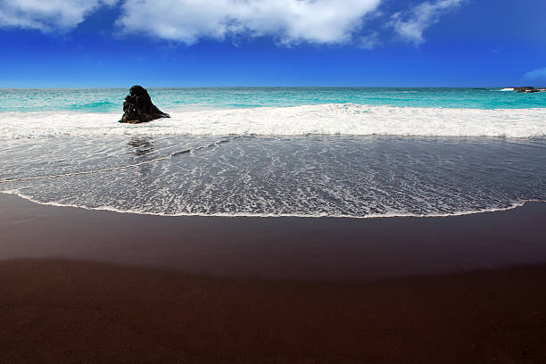 istock Beach el Bollullo black brown sand and aqua water 474612986