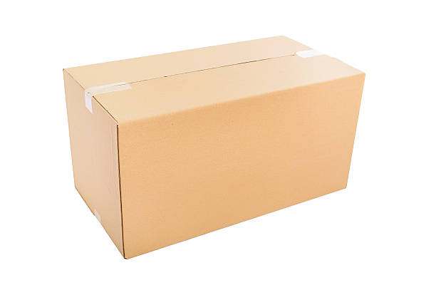 Cardboard box Closed cardboard box taped up and isolated on a white background. big cardboard box stock pictures, royalty-free photos & images