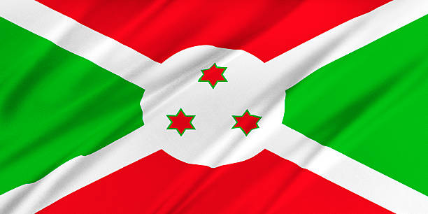 Small paper flag of Burundi pinned. Isolated on white background. Horizontal orientation. Close up photography. Copy space.