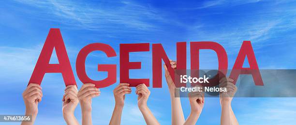 Hands Holding Red Straight Word Agenda Blue Sky Stock Photo - Download Image Now - 2015, Blue, Business