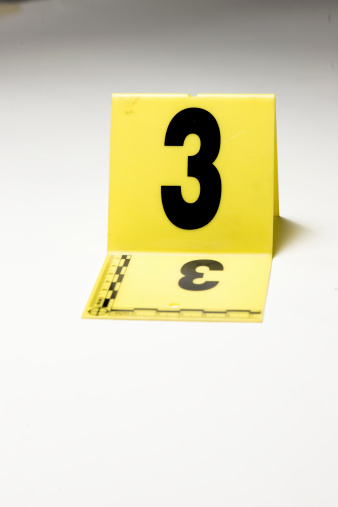 A yellow crime scene marker with the #3 on it.