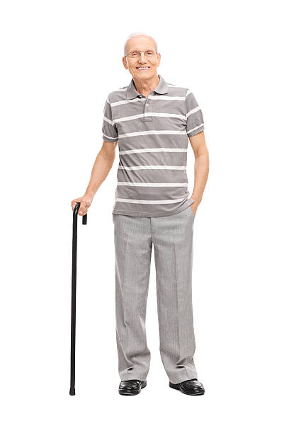 istock Old man in polo shirt holding a cane and posing 474618514