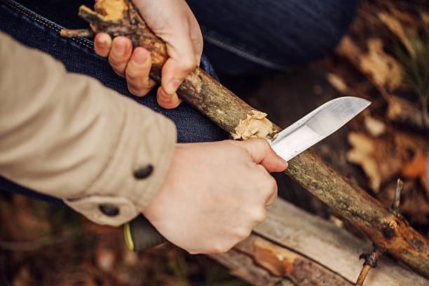 istock Girl cuts a stick a knife 474619016