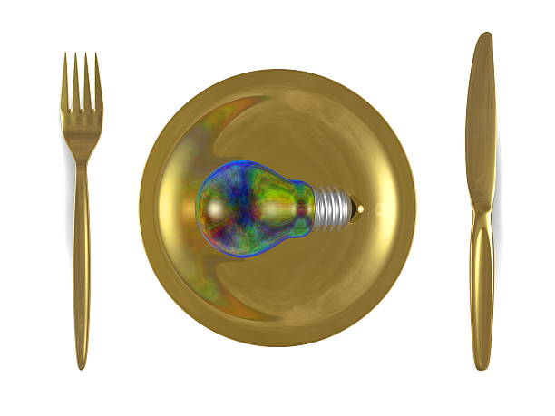 istock Multicolored iridescent lightbulb, golden plate, fork and knife. Top view 474619325
