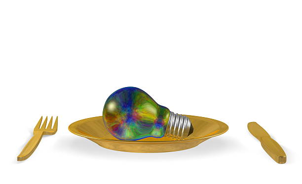 istock Multicolored iridescent light bulb, golden plate and cutlery. Front view 474619587