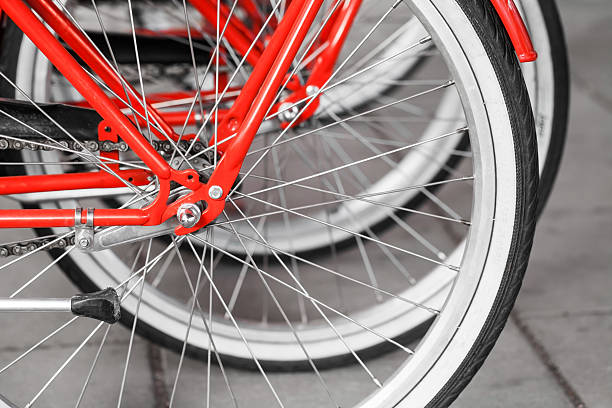 istock Parked red street bicycles for rent, rear wheels 474619654